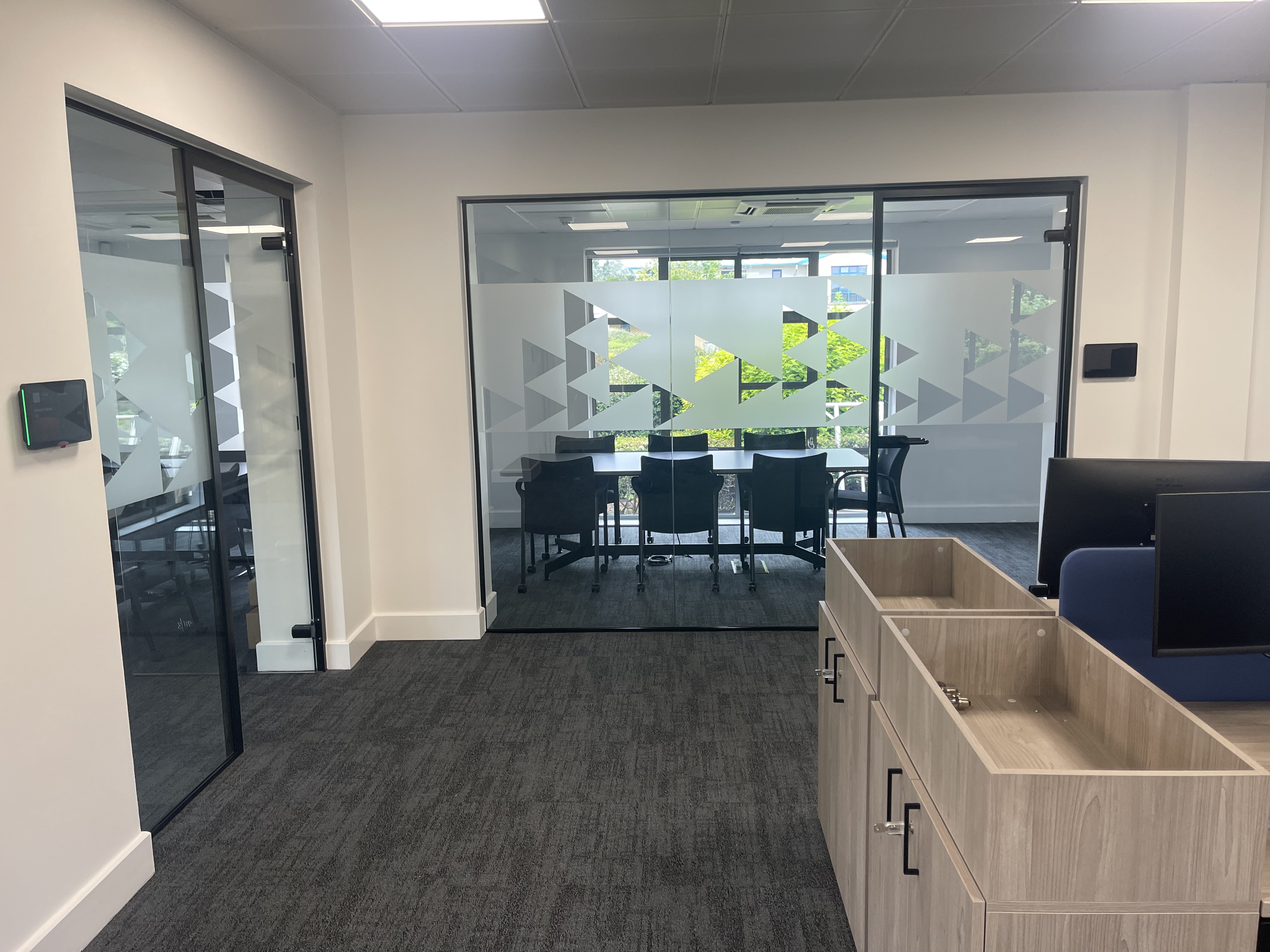 Clean commercial office reception and meeting-room entrance