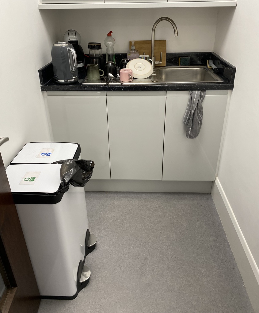 Staff kitchenette with a sink, worktop and recycling bins
