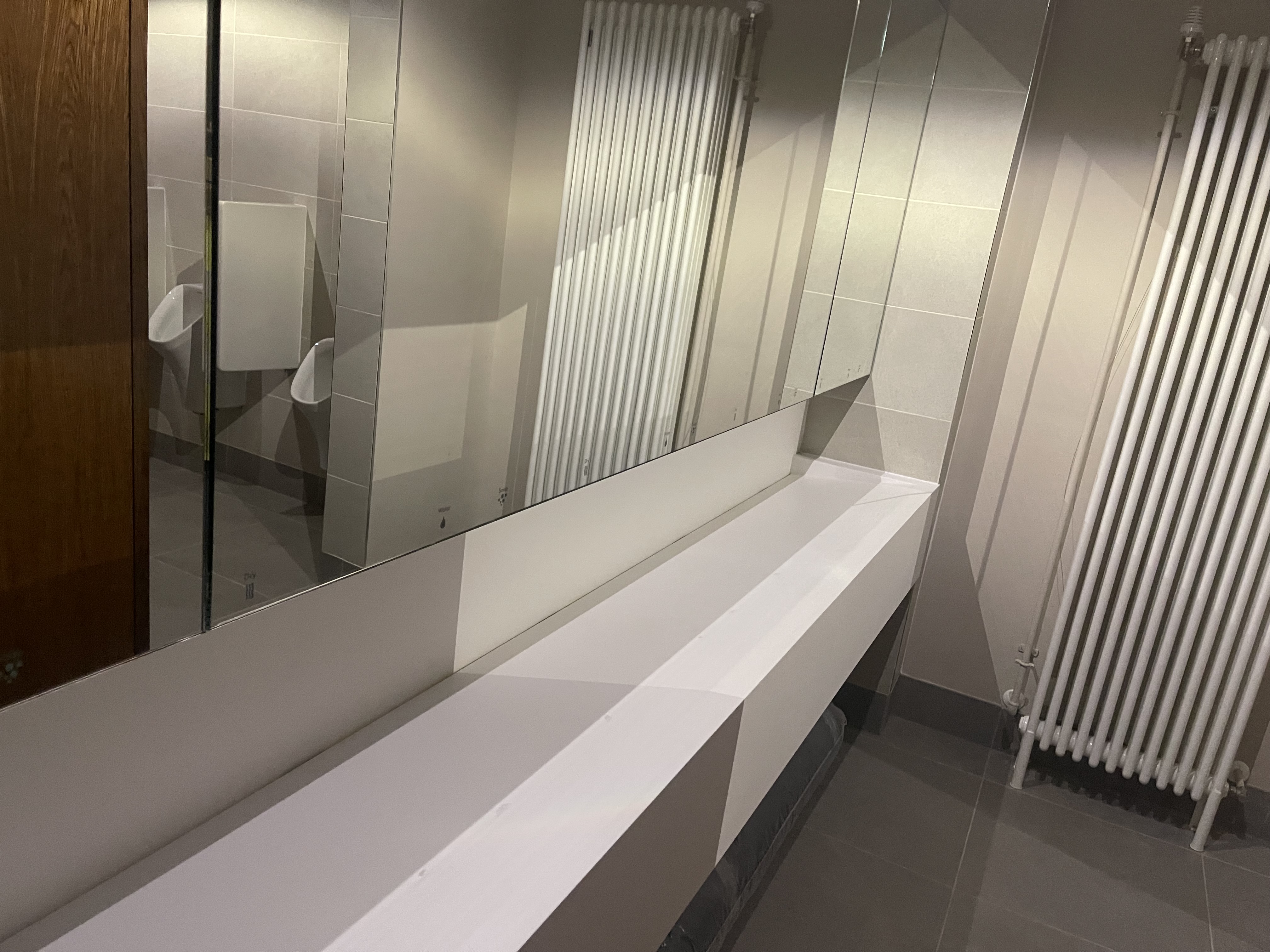Clean modern washroom sinks and mirrors at a visitor venue